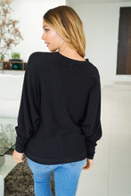 A long sleeve solid knit top with a v-neck featuring a cut out detail and a dolman sleeve - Black, Fuchsia or Royal Blue