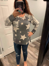 Long sleeve star print knit top with a round neck featuring a tie dye patch pocket, tie dye trim, and a side slit - Grey or Taupe