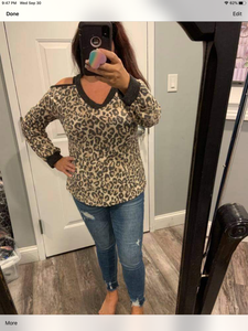 long sleeve leopard print knit top with a v-neck featuring a cold shoulder and a solid trim detail.