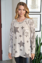 Long sleeve star print knit top with a round neck featuring a tie dye patch pocket, tie dye trim, and a side slit - Grey or Taupe