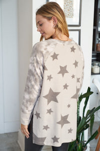 Long sleeve star print knit top with a round neck featuring a tie dye patch pocket, tie dye trim, and a side slit - Grey or Taupe