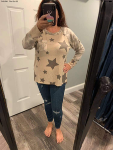 PLUS Long sleeve star print knit top with a round neck featuring a tie dye patch pocket, tie dye trim, and a side slit - Grey or Taupe