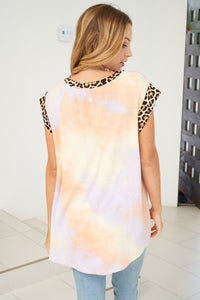 A short sleeve tie dye knit top with a round neck featuring a leopard print trim detail - Peach