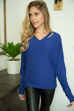 A long sleeve solid knit top with a v-neck featuring a cut out detail and a dolman sleeve - Black, Fuchsia or Royal Blue