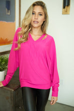 A long sleeve solid knit top with a v-neck featuring a cut out detail and a dolman sleeve - Black, Fuchsia or Royal Blue