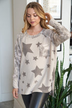 Long sleeve star print knit top with a round neck featuring a tie dye patch pocket, tie dye trim, and a side slit - Grey or Taupe